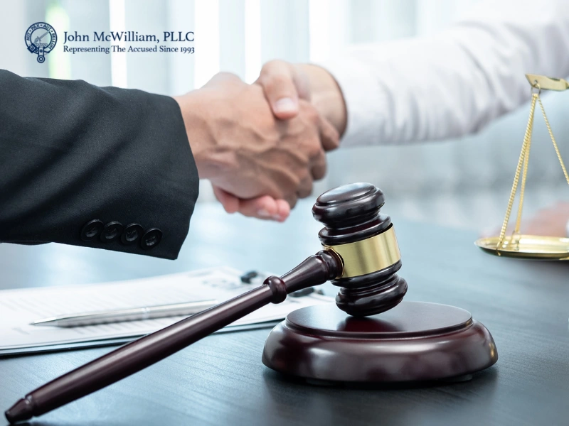 Lawyer handshake with gavel representing suspended license defense in Raleigh, NC